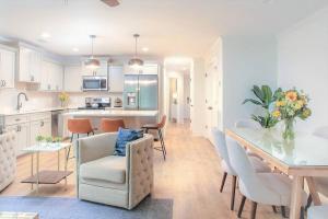 a kitchen and living room with a table and chairs at Magnolia Garden - Ground Level, Easy Parking in Savannah