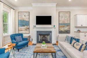 a living room with a couch and a fireplace at Magnolia House - 3BR, Downtown, Easy Parking in Savannah