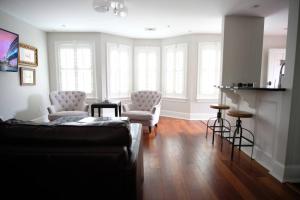 a living room with two chairs and a couch at Carriage House B at Hamilton in Savannah