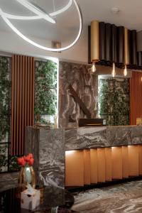 a kitchen with a marble counter top and some windows at NED Hotel in Graz