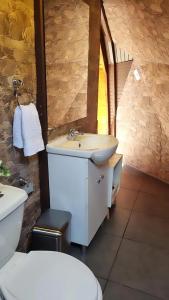 a bathroom with a sink and a toilet at Domos kupellon in Santiago
