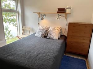 En eller flere senge i et værelse på Cozy cottage with its own bathing cliff located at Odensvi
