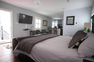 a bedroom with a large bed and a dining room at Hamilton Carriage A - Amazing Location, Courtyard in Savannah
