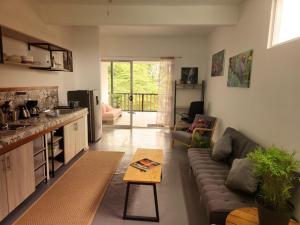 a living room with a couch and a table at El Hábita CASA MAR in Santa Teresa Beach