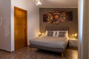 a bedroom with a bed and two paintings on the wall at Tenuta Lunoa in Salandra +28 photos