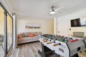 a living room with a foosball table in front of a couch at Serene Sunsets at Indian Cove in Clearwater Beach