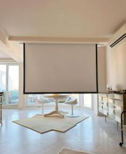 a large screen in the middle of a room at Groovy Caparica Gem with Large Sunny Terrace in Costa da Caparica