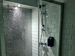 a shower with a glass door in a bathroom at Luxury apartament airport in Málaga