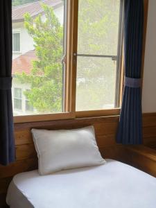 Postel nebo postele na pokoji v ubytování Moment Chalet Hakuba