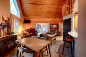 a living room with a wooden ceiling and a table at Corporate Cabin Aurora Refuge in Fairbanks