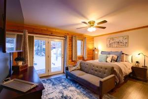 a bedroom with a bed and a ceiling fan at Corporate Cabin Aurora Refuge in Fairbanks