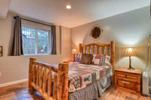 a bedroom with a wooden bed and a window at Beaver Lodge MTN Town Escape GMF in Green Mountain Falls