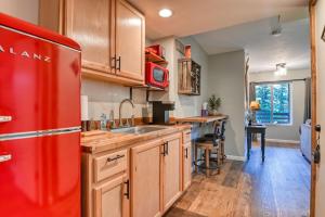a kitchen with a red refrigerator and wooden cabinets at Beaver Lodge MTN Town Escape GMF in Green Mountain Falls +19 photos