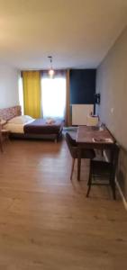 a room with a desk and a bed and a table at OLOO Habitat - Le19 - Parking Privé in Montbéliard