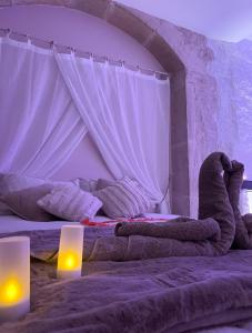a bedroom with two beds with lights on them at La voute Doloise - Love room & spa in Dole