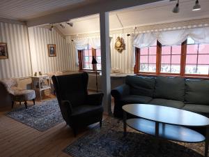 a living room with a couch and a table at Vargheden Bed & Breakfast in Malung