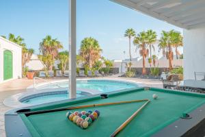 a pool table with balls on it in a swimming pool at Villa Milan in Puerto del Carmen