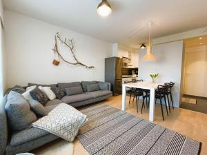 a living room with a couch and a table at Syöte Panorama in Syöte