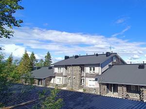 a large stone house with a black roof at Syöte Panorama in Syöte