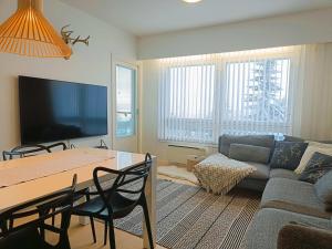a living room with a table and a couch at Syöte Panorama in Syöte