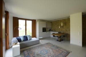 a living room and kitchen with a couch and a table at Scheier (Ferienwohnungen) in Perl