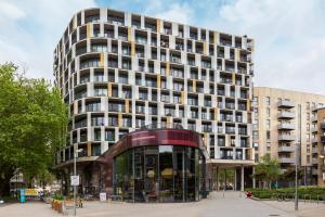 a tall building with a glass entrance in front of it at The Hackney Studio Apartments in London