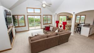 a living room with a couch and a tv at Oceanside, Pool, Hot Tub, Close to Beach, OH1, Silver Sandcastle in Corolla