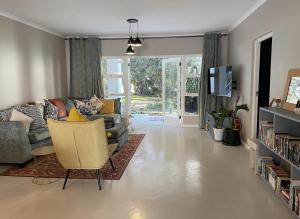 a living room with a couch and a chair at Villa Songo, Estuary Country Estate, INVERTER & RENOVATED in Port Edward