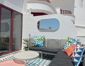 a patio with chairs and a table and a window at Groovy Caparica Gem with Large Sunny Terrace in Costa da Caparica