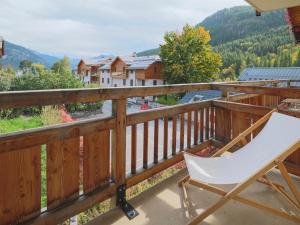 a white chair sitting on a balcony with a view at Studio Saint-Chaffrey , 1 pièce, 3 personnes - FR-1-762-11 in Saint-Chaffrey