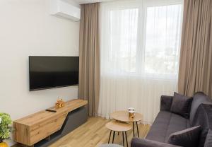sala de estar con sofá y TV en Brand New Modern 1BD Flat In Chayka with Parking, en Varna