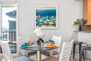 a dining room with a table with chairs and a painting at Kapalua Bay Villa 32B3 in Honokahua