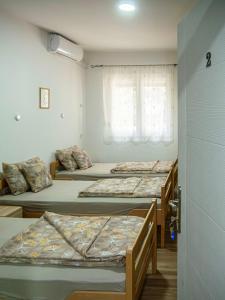 a group of four beds in a room at Sobe Marija in Kikinda