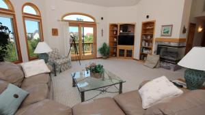 a living room with couches and a fireplace at Oceanside, Close to Beach, Priv Pool, Rec Rm, OH57, Sea-Crets in Corolla