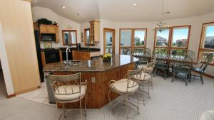 a kitchen and dining room with a table and chairs at Oceanside, Close to Beach, Priv Pool, Rec Rm, OH57, Sea-Crets in Corolla