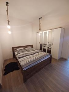a bedroom with a bed and a mirror at Apartma in Izimje