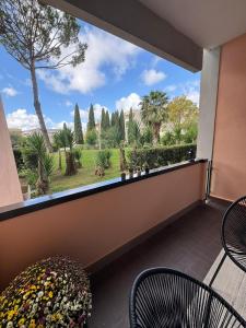 a balcony with chairs and a view of trees at Aurelia Green Suite in Rome