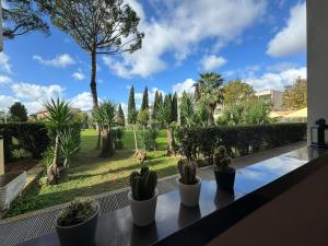 a view of a garden from a balcony with cactus at Aurelia Green Suite in Rome