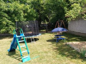 a playground with a slide and a swing at Chata Sovička Podhájska in Podhájska