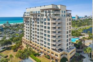 an aerial view of a white building with the ocean in the background at Luau at Sandestin Tower I & II in Destin