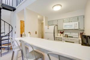 a kitchen with white cabinets and white appliances at Cozy Condo with Balcony - Near Big Sky Resort! in Big Sky