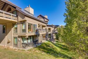 an exterior view of a house with trees at Cozy Condo with Balcony - Near Big Sky Resort! in Big Sky