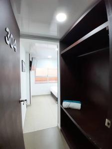 a room with a hallway with a bed and a door at Apartamento Grupal, Chapinero in Bogotá