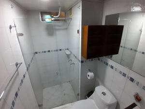 a bathroom with a shower and a white toilet at Apartamento Grupal, Chapinero in Bogotá