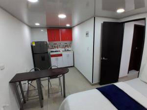 a small kitchen with a table and a refrigerator at Apartamento Grupal, Chapinero in Bogotá
