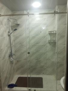 a shower with a glass door in a bathroom at Квартира in Dushanbe