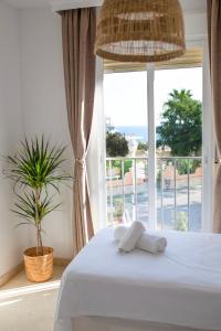 a bedroom with a bed and a large window at Marina del Sol apartment by Wyndham in Fuengirola