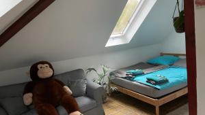 a stuffed monkey sitting on a couch next to a bed at Five Oaks Sky in Hamburg