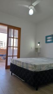 a large bed in a room next to a door at Chalés Manacá da Serra in Ubatuba