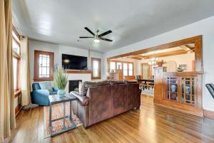 a living room with a leather couch and a table at Classen Craftsman-near Asian & Paseo district in Oklahoma City